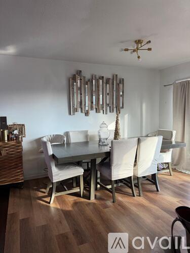 A dining room with a table set for four.