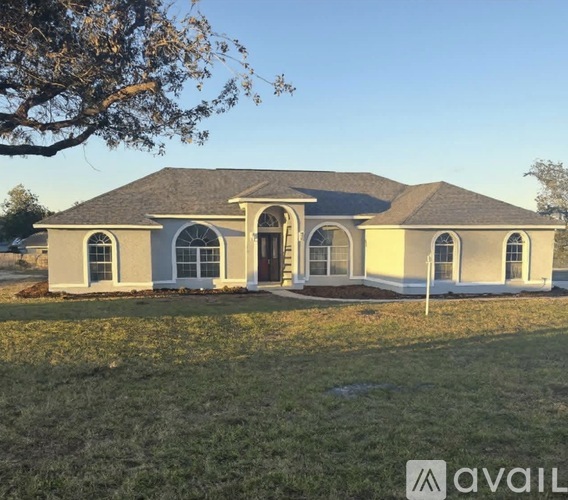 A house with a brown roof and a white garage door is available for sale.