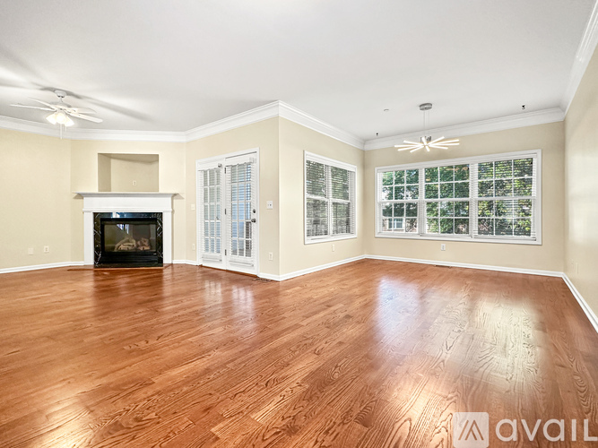 A living room with wood flooring and a fireplace.