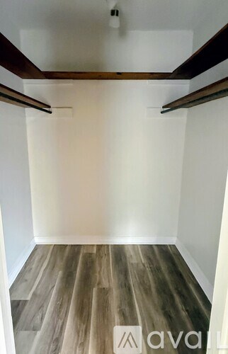 A room with wooden floors and white walls.