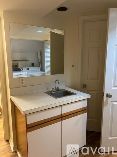 A bathroom with a sink and mirror.