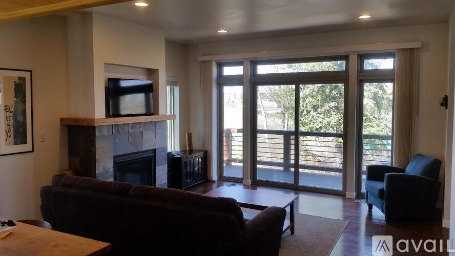 A living room with a fireplace and sliding glass doors.