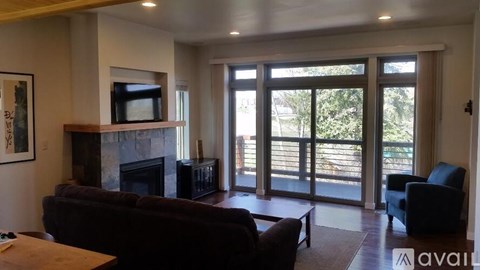 A living room with a fireplace and sliding glass doors.