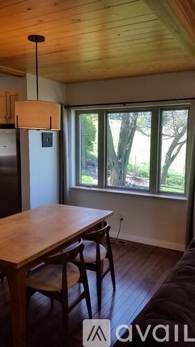 A kitchen with a table and chairs and a window.