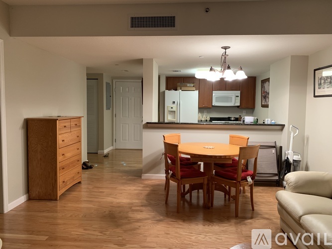 A kitchen with a table and chairs in the middle of the room.