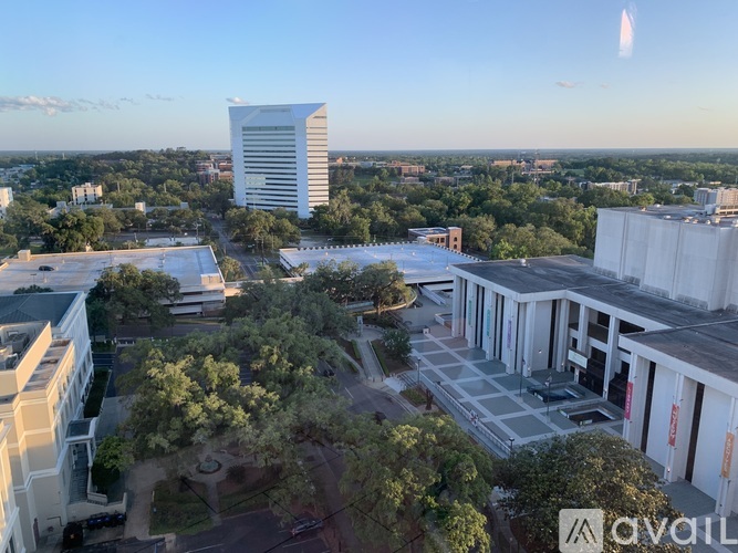 A view of a cityscape with buildings and trees from an aerial perspective.