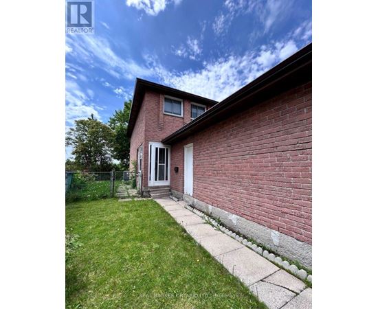 A red brick house with a white door and a small porch.