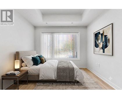 A bedroom with a large bed and a painting on the wall.