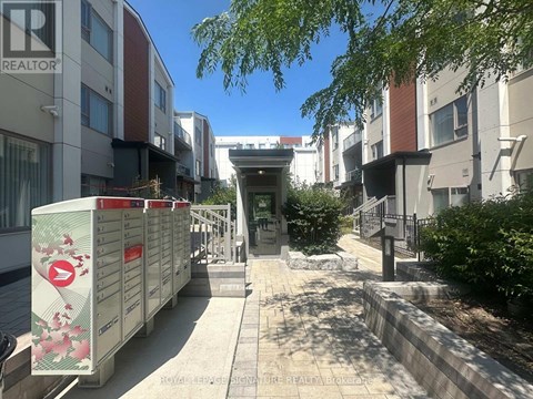 A row of mailboxes in front of apartment buildings.