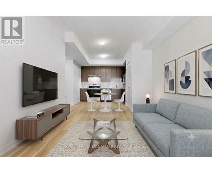 A living room with a grey couch and a wooden coffee table.