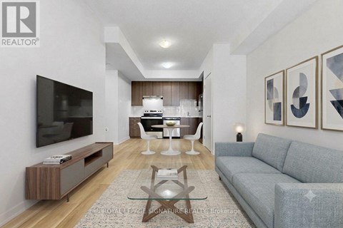 A living room with a grey couch and a wooden coffee table.