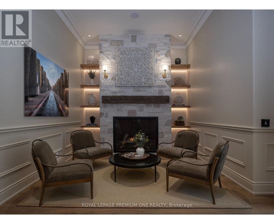 A living room with a fireplace and a painting on the wall.