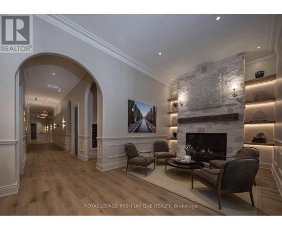 A living room with a fireplace and a painting on the wall.