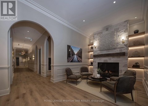 A living room with a fireplace and a painting on the wall.