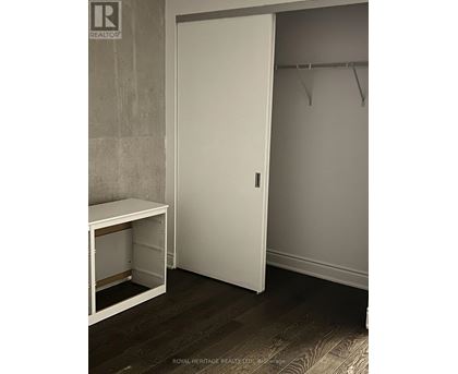 A white closet door with a white bench below it.
