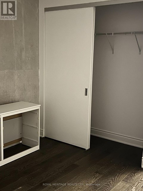 A white closet door with a white bench below it.