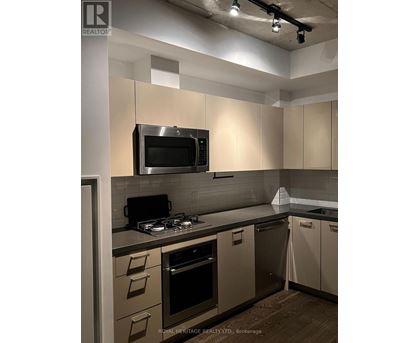 A kitchen with a stove top oven and microwave.