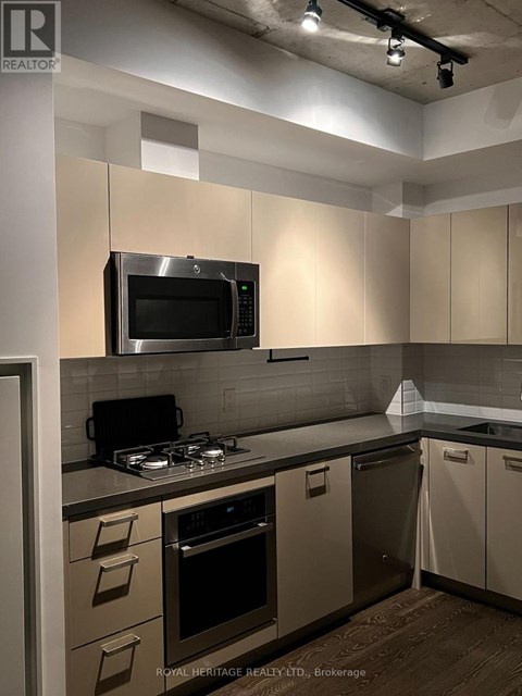 A kitchen with a stove top oven and microwave.