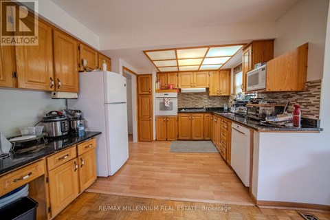 A kitchen with wooden cabinets and a white refrigerator.