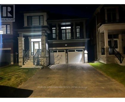 A nighttime view of a house with the entrance illuminated.