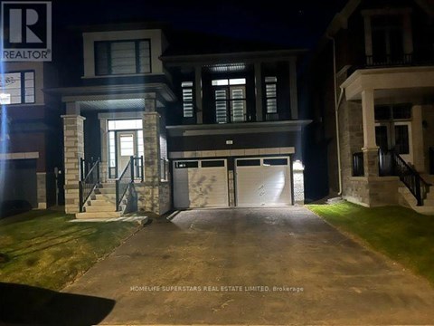 A nighttime view of a house with the entrance illuminated.