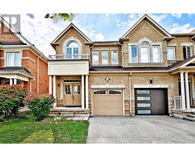 A large, two-story house with a garage and a driveway.