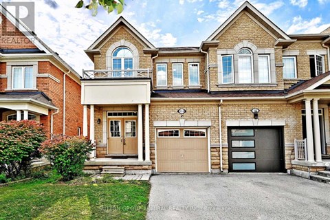 A large, two-story house with a garage and a driveway.