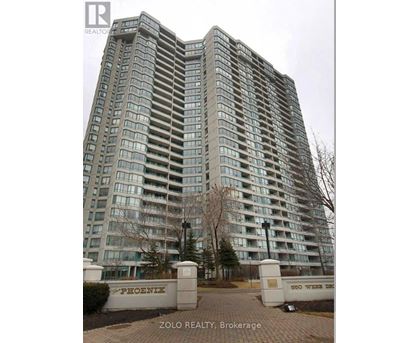 A tall building with the name "PHOENIX" on the gate in front of it.