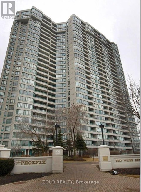 A tall building with the name "PHOENIX" on the gate in front of it.