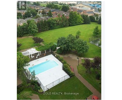 A pool surrounded by a fence and trees in a yard.