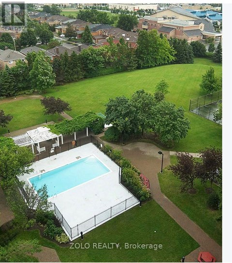 A pool surrounded by a fence and trees in a yard.