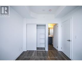 A white room with a doorway leading to another room.
