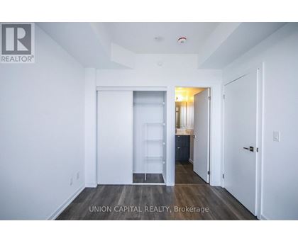 A white room with a doorway leading to another room.