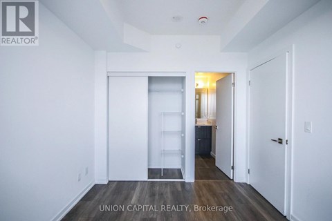 A white room with a doorway leading to another room.