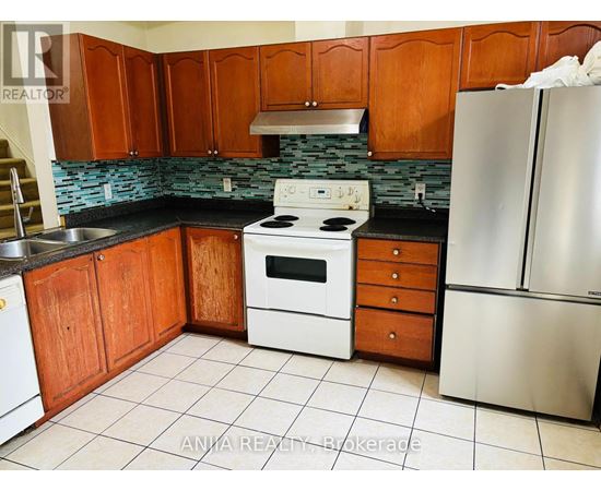 A kitchen with wooden cabinets and a stove top oven.