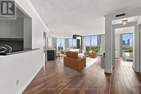 A modern living room with a kitchen area in the background.