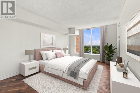 A bedroom with a large bed and a view of the outside.