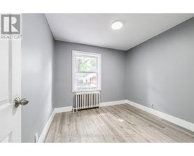 A room with a door, window, and radiator.