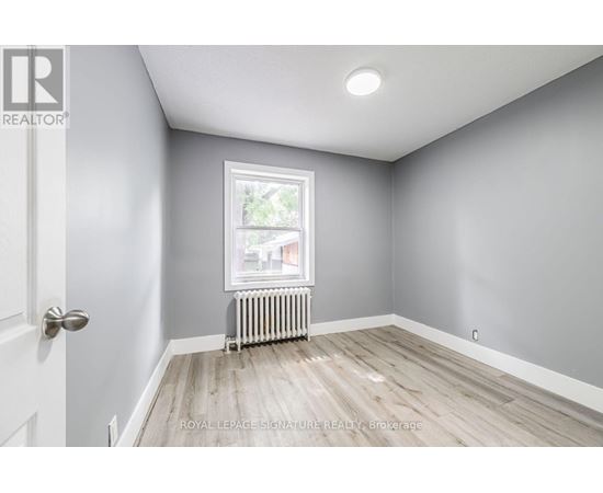 A room with a door, window, and radiator.