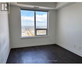 A room with a large window overlooking a cityscape.