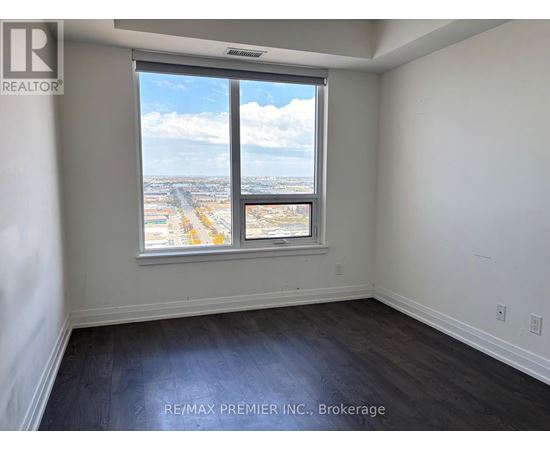 A room with a large window overlooking a cityscape.