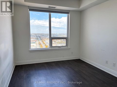 A room with a large window overlooking a cityscape.