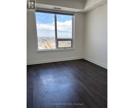 A room with a large window overlooking a cityscape.