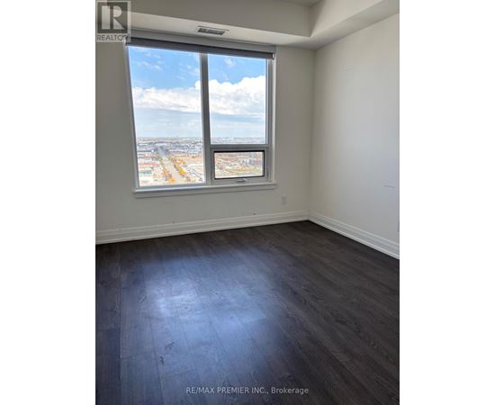 A room with a large window overlooking a cityscape.