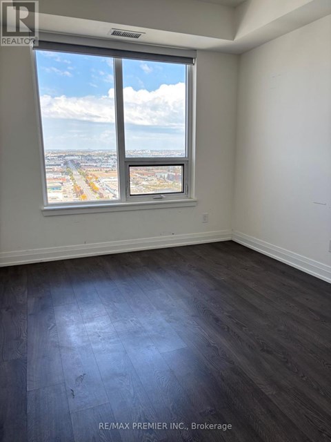 A room with a large window overlooking a cityscape.