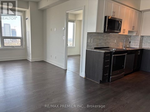 A kitchen with a black stove top oven and microwave.