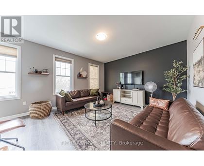 A living room with a brown leather couch and a glass coffee table.