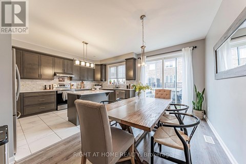 A modern kitchen and dining area with a wooden table and chairs.
