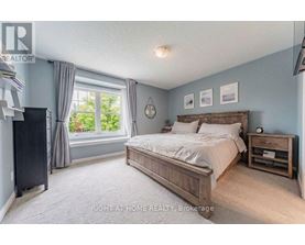 A bedroom with a large bed and a window with curtains.