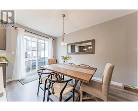 A dining room with a wooden table and chairs.
